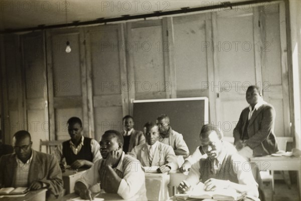 Theology students training to be priests. Theology students training to be priests attend a class at St. Paul's United Theological College in Limuru. The college was established by missionaries to train African ordinands for the priesthood and to educate their wives. Limuru, Kenya, circa 1956. Limuru, Central (Kenya), Kenya, Eastern Africa, Africa.