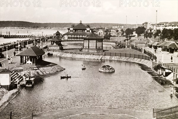 Children's outdoor pool, Durban. Two children paddle canoes on an outdoor boating pool near the seafront in Durban. Durban, Natal (KwaZulu Natal), South Africa, circa 1936. Durban, KwaZulu Natal, South Africa, Southern Africa, Africa.