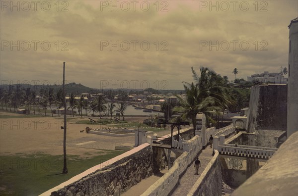 Elmina Castle and St Jago Fort. View from the walls of Elmina Castle looking towards St Jago Fort. Ghana, circa 1965. Elmina, Central (Ghana), Ghana, Western Africa, Africa.