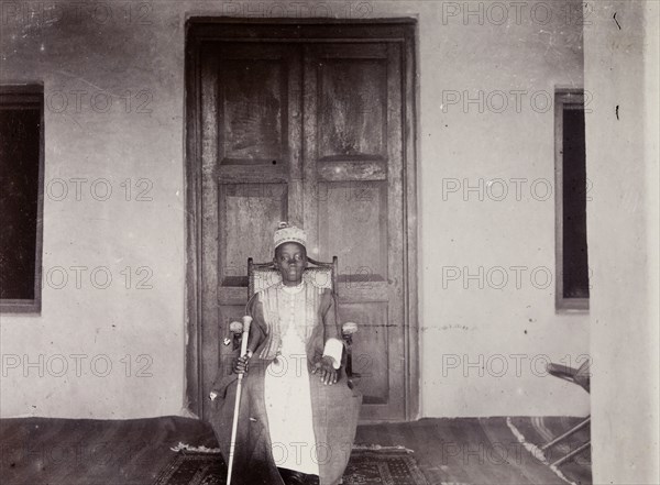 Daudi Chwa II, Kabaka of Buganda. Portrait of Daudi Chwa II, Kabaka (king) of Buganda, seated before a large doorway. Buganda, Uganda, 1906. Uganda, Eastern Africa, Africa.