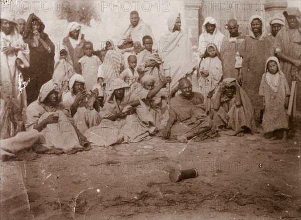 Storytelling at Safi. A 'halca' (audience) of Moroccan locals watches intently as a 'halaiqui' (storyteller) recites his traditional tales. Safi, Morocco, 1898. Safi, Safi, Morocco, Northern Africa, Africa.