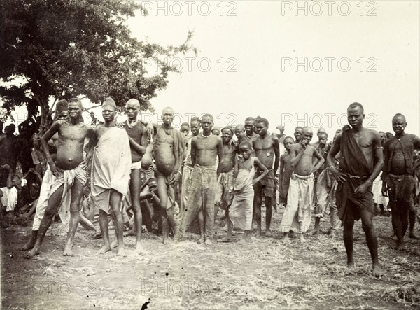 Nyamwezi porters. A crowd of male Nyamwezi porters stand, staring into the camera. German East Africa (Tanzania), 1906. Tanzania, Eastern Africa, Africa.