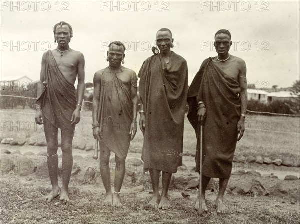 Four Kikuyu men. Group portrait of four Kikuyu men wearing traditional dress and jewellery. British East Africa (Kenya), 1906. Kenya, Eastern Africa, Africa.