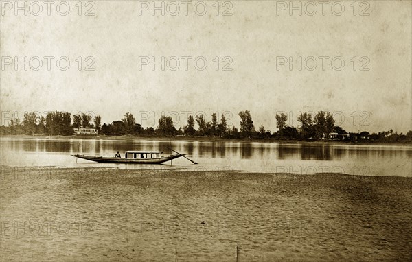 Hooghly River, West Bengal. A lone fishing boat rests on the calm waters of the Hooghly River. West Bengal, India, circa 1890. Kolkata, West Bengal, India, Southern Asia, Asia.