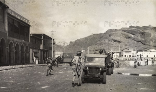 Patrols during the Arab riots in Aden, 1947. Armed police or soldiers patrol the streets of Aden in a convoy of armoured vehicles, during the Arab riots that took place between 1-3 December 1947 in response to the United Nations Partition Plan for Palestine. Aden, Yemen, December 1947. Aden, Adan, Yemen, Middle East, Asia.