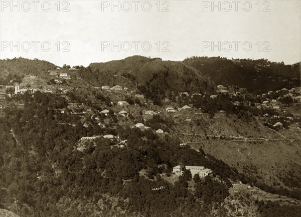 Mussoorie hill station, India. Houses cling to the forested mountainside at Mussoorie hill station, located at an altitude of around 2000m in the Himalayan foothills of northern Indian. Mussoorie, India, circa 1890. Mussoorie, Uttaranchal, India, Southern Asia, Asia.