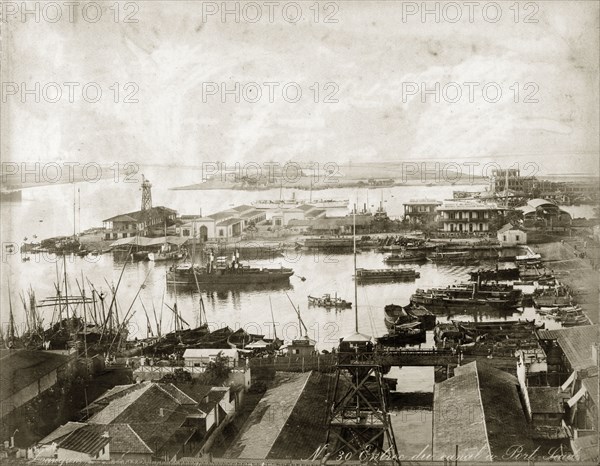 Entrance to the Suez Canal at Port Said. Vessels moored at a Port Said harbour at the entrance to the Suez Canal. Port Said, Egypt, circa 1885. Port Said, Port Said, Egypt, Northern Africa, Africa.