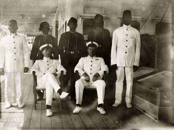 Engine room officials. Group portrait of six uniformed engineer room officials posed on the deck of RIMS 'Investigator'. Indian Ocean, circa 1900., Southern Asia, Asia.