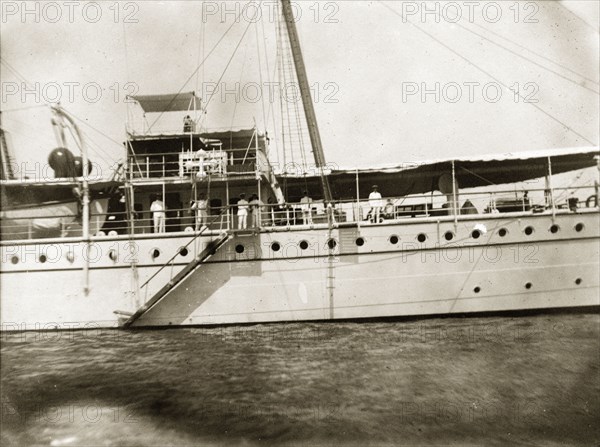 Waving goodbye. Officers aboard RIMS 'Investigator' wave goodbye to G.E. Wood (the photographer and an officer in the Royal Indian Marine Service) as he transfers service to RIMS 'Mayo'. Indian Ocean, circa 1900., Southern Asia, Asia.