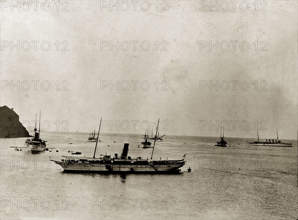 RIMS 'Minto' and fleet. RIMS 'Minto' and her fleet float off shore. These ships belong to the East India Squadron, part of the Persian Gulf Operations Fleet. Probably the Persian Gulf, circa 1900., Middle East, Asia.