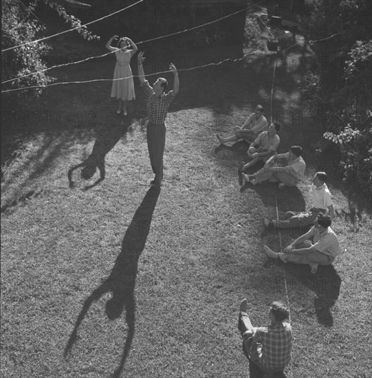 Dance rehearsal, Kenya. The long shadows of two ballet dancers extend across a lawn at a practice rehearsal for a square dance cabaret. Kenya, 7 December 1952. Kenya, Eastern Africa, Africa.