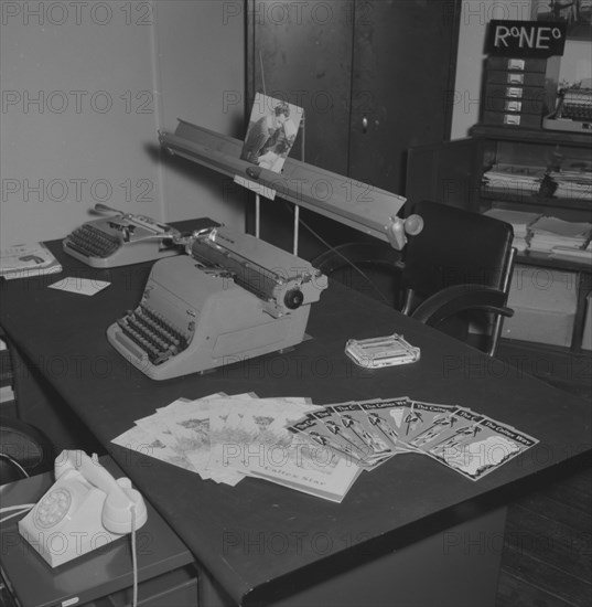 East Africa Standard office. Interior of an East African Standard newspaper office kitted out with a telephone and two typewriters. A fan of leaflets are displayed on the desk advertising 'The Caltex Way'. Kenya, 25 September 1957. Kenya, Eastern Africa, Africa.