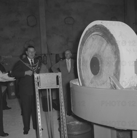 Leyland Paint Factory. A Mayor, dressed in a suit and ceremonial chain, prepares to start machinery at the opening of a new Leyland Paint Factory. Kenya, 12 October 1957. Kenya, Eastern Africa, Africa.