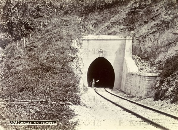 Railway tunnel 'No. 1', Jamaica. A man stands at the entrance to a newly constructed railway tunnel cut into the side of a mountain. Identified as 'No.1 Tunnel', the keystone on its face bears the date '1893'. Jamaica, circa 1895. Jamaica, Caribbean, North America .