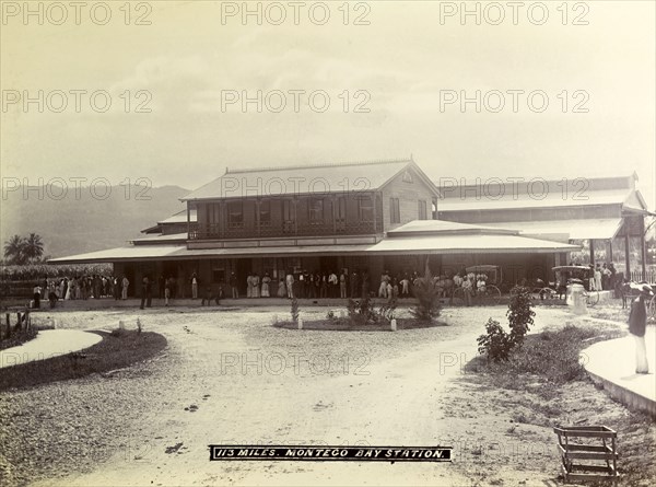 Montego Bay railway station. A crowd of passengers waits on the veranda outside Montego Bay station. Montego Bay, Jamaica, circa 1895. Montego Bay, St James (Jamaica), Jamaica, Caribbean, North America .