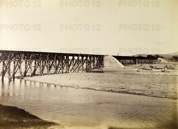 Port Antonio extension line. A narrow trestle bridge carries the Port Antonio railway extension line across a river. Portland, Jamaica, circa 1895., Portland, Jamaica, Caribbean, North America .