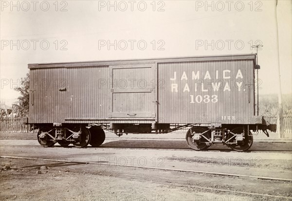 Box carriage, Jamaica. A box carriage inscribed 'Jamaica Railway 1033' sits on rails at a siding. Jamaica, circa 1895. Jamaica, Caribbean, North America .