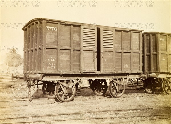 Jamaica Railway box wagon. An box railway wagon inscribed 'No. 76', sits on rails at a siding. Jamaica, circa 1895. Jamaica, Caribbean, North America .