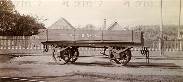 Jamaica Railway wagon. An open railway wagon inscribed 'J.R. No.187', sits on rails at a siding. Jamaica, circa 1895. Jamaica, Caribbean, North America .