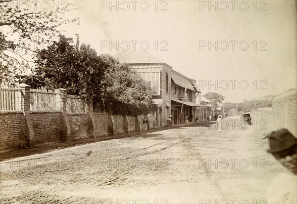 Kingston tram lines. Rails laid down for mule-drawn trams stretch into the distance along a long, empty road. Kingston, Jamaica, circa 1895. Kingston, Kingston, Jamaica, Caribbean, North America .