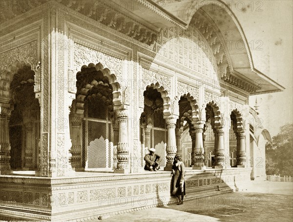 Bhaldwun Singh's Palace. Two figures engage in conversation outside the decorative walls of Bhaldwun Singh's Palace. Benares, North Western Provinces (Varanasi, Uttar Pradesh), India, circa 1880. Varanasi, Uttar Pradesh, India, Southern Asia, Asia.