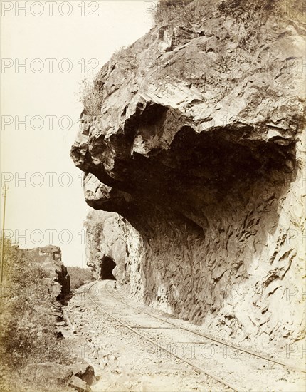 Colombo to Kandy railway. A section of mountainside has been cut away to make access for the Colombo to Kandy railway, leaving a large overhang of rock above the tracks. Central Province, Ceylon (Sri Lanka), circa 1885., Central (Sri Lanka), Sri Lanka, Southern Asia, Asia.