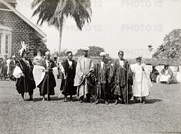 Bechuanaland chiefs. A group of finely dressed Bechaunaland chiefs pose for the camera holding staffs at an outdoor reception held for the Duke of Connaught. This was one of several stops made by the Duke following his official visit to Cape Town to open the new Union Parliament. Gaberones, Bechuanaland (Gaborone, Botswana), 24 November 1910. Gaborone, South East (Botswana), Botswana, Southern Africa, Africa.