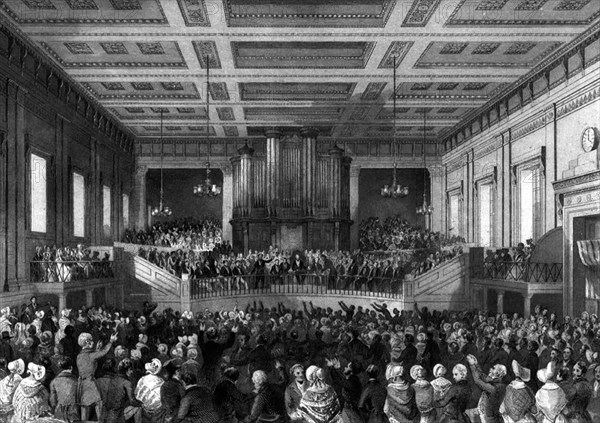 Anti-slavery meeting. A crowd of anti-slavery campaigners pack out a large hall to air their grievances at an official meeting. England, circa 1850. England (United Kingdom), Western Europe, Europe .