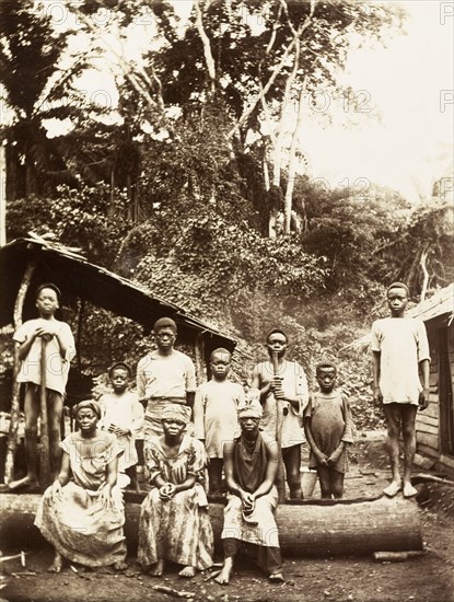 Villagers of Bioko. A group of men, women and children from Bioko line up for the camera in a rural village. Bioko, Equatorial Guinea, circa 1930., Bioko Norte, Equatorial Guinea, Central Africa, Africa.