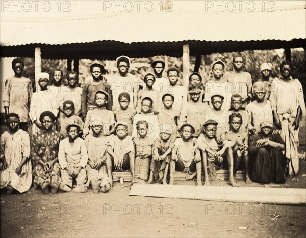 Inhabitants of Bioko. A group of men, women and children from Bioko line up for the camera. Bioko, Equatorial Guinea, circa 1930., Bioko Norte, Equatorial Guinea, Central Africa, Africa.