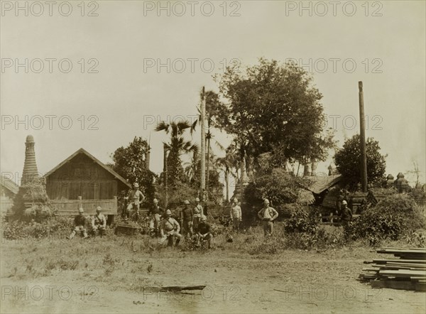 Soldiers at a deserted shrine. British Army soldiers pose informally at a deserted shrine containing several carved stone 'zeidis' or pagodas. The group are pictured shortly after British forces captured Wuntho following a conflict with Burmese rebels. Wuntho, Burma (Myanmar), 1891. Wuntho, Sagaing, Burma (Myanmar), South East Asia, Asia.