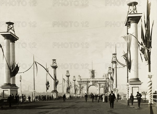 Decorations for the royal visit, Melbourne. An archway and columns are decorated with flags, part of celebrations to welcome the Duke and Duchess of Cornwall and York (later King George V and Queen Mary) to Melbourne to open the first Commonwealth Parliament of Australia. Melbourne, Australia, May 1901. Melbourne, Victoria, Australia, Australia, Oceania.