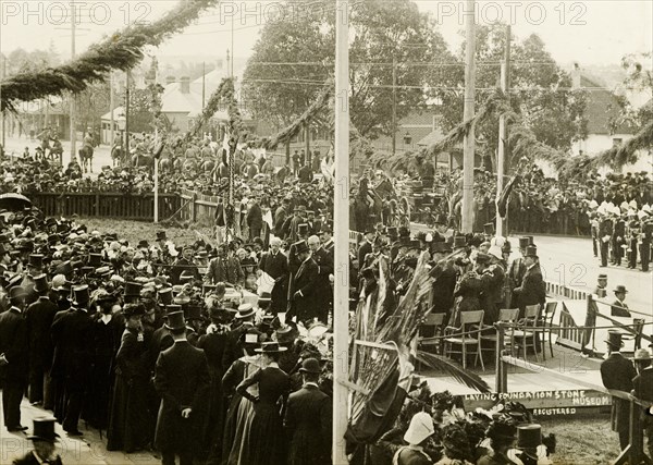 Laying the foundation stone for a new museum. A crowd gathers to watch the Duke of Cornwall and York (later King George V) lay the foundation stone of a new musuem. The Duchess was also present during the visit, which was made shortly after the royal couple had opened the first Commonwealth Parliament of Australia in Melbourne. Perth, Australia, 24 July 1901. Perth, West Australia, Australia, Australia, Oceania.