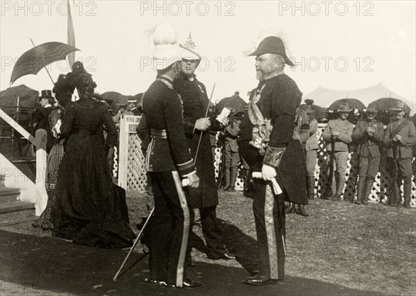 Sir John Forrest awaits the Bishop of Perth. Sir John Forrest (right), the Australian Federal Minister of Defence, talks with two military officers as they await the arrival of the Bishop of Perth at an official ceremony. Perth, Australia, circa 1902. Perth, West Australia, Australia, Australia, Oceania.