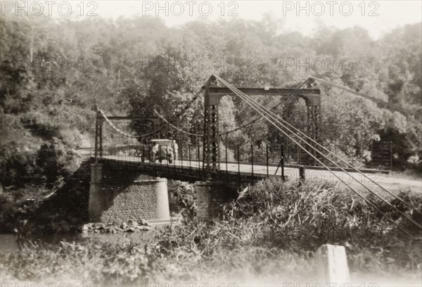 Tahsai Bridge in Shan State. View of a motorcar parked on Tahsai suspension bridge over the Salween River. Tahsai, Burma (Myanmar), December 1928. Tahsai, Shan, Burma (Myanmar), South East Asia, Asia.