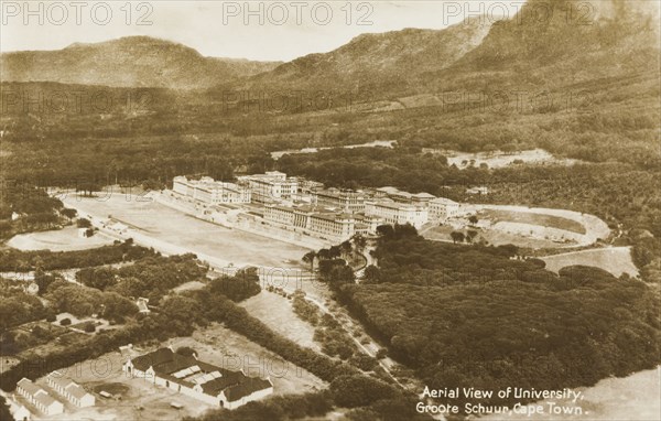 University of Cape Town on the Groote Schuur Estate. Aerial view of the University of Cape Town, nestled at the foot of mountains on the Groote Schuur Estate. The first new university buildings at Groote Schuur were ready for occupation in 1928, with the majority of university departments transferring there by 1930. Cape Town, Cape Province (West Cape), South Africa, circa 1930. Cape Town, West Cape, South Africa, Southern Africa, Africa.