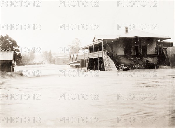 Flooding in Bloemfontein. A burst dam resulting from freak rainfall causes a flood to rampage down a street in Bloemfontein, sweeping away buildings in its path. 176 buildings and shops were destroyed by the flood, and approximately 25 people lost their lives. Bloemfontein, South Africa, 17 January 1904. Bloemfontein, Free State, South Africa, Southern Africa, Africa.