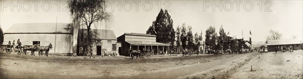 Decorated street in Lydenburg. Panoramic view of a street in Lydenburg, decorated with flags and a welcome arch in honour of Sir Arthur Lawley (1860-1932), Lieutenant Governor of the Transvaal. Sir Lawley was visiting to present the New Year and Birthday Honours on behalf on King Edward VII. Lydenburg, South Africa, 1903. Lydenburg, Mpumalanga, South Africa, Southern Africa, Africa.