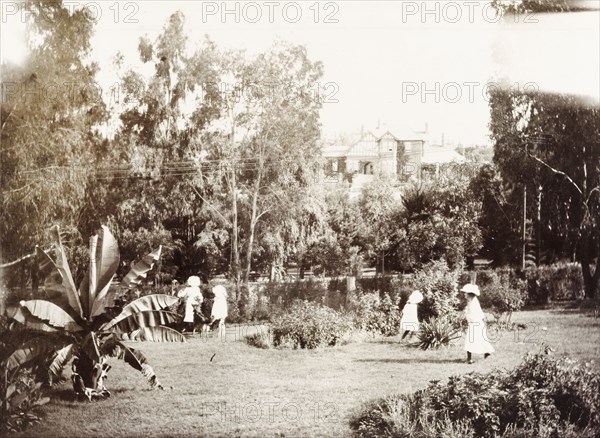 Children play in grounds of the Governor's residence. Cecilia and Ursula Lawley, the daughters of Sir Arthur Lawley, Lieutenant Governor of the Transvaal, play with two friends in the garden at 'Sunnyside', the residence of Lord Alfred Milner, High Commissioner and Governor of the Transvaal and Orange Free State. Johannesburg, South Africa, circa 1903. Johannesburg, Gauteng, South Africa, Southern Africa, Africa.