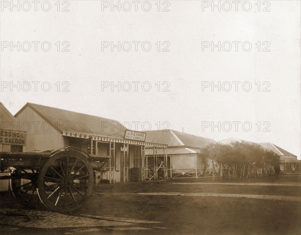 A street in Mafeking. A street in Mafeking, lined with low, colonial-style commercial buildings. Mafeking (Mafikeng), South Africa, circa 1896. Mafikeng, North West (South Africa), South Africa, Southern Africa, Africa.