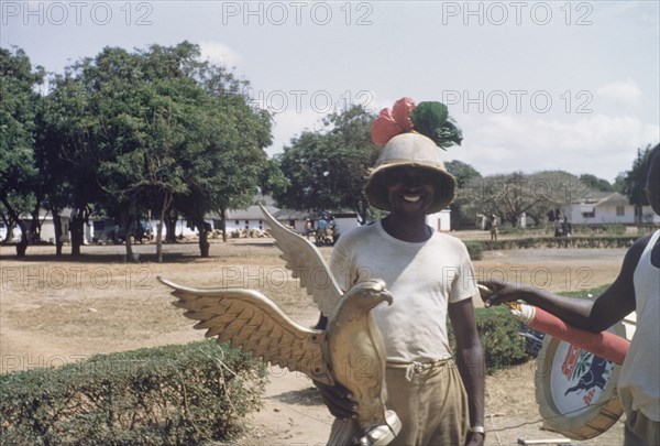 Third anniversary of Ghanaian independence. Public Works Department labourers erect street decorations to commemorate the third anniversary of Ghanaian independence. Accra, Ghana, circa March 1960. Accra, East (Ghana), Ghana, Western Africa, Africa.