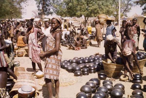 Pot section at Bolgatanga market. Traders and customers bustle about amidst the pot section at Bolgatanga market. Bolgatanga, Ghana, circa 1961. Bolgatanga, Upper East, Ghana, Western Africa, Africa.