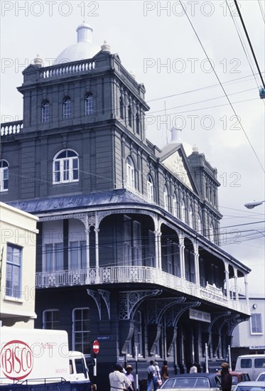 The Barclay's Bank in Barbados. The facade of the colonial-style Barclay's Bank building in Barbados. The three-storey building features two square towers, an ornate iron balcony and a sculptured pediment. Barbados, circa 1975. Barbados, Caribbean, North America .