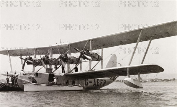 Imperial Airways flying boat. Men attend to an Imperial Airways flying boat resting on Lake Victoria. Kenya, 1933. Kenya, Eastern Africa, Africa.