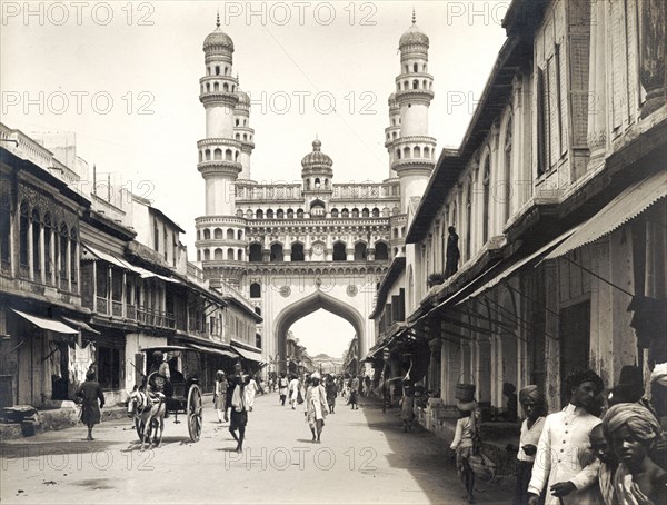 Street leading to the Charminar. Shops with awnings flank a street leading towards the Charminar monument, an important landmark at the centre of a thriving market. Hyderabad, India, circa 1880. Hyderabad, Andhra Pradesh, India, Southern Asia, Asia.