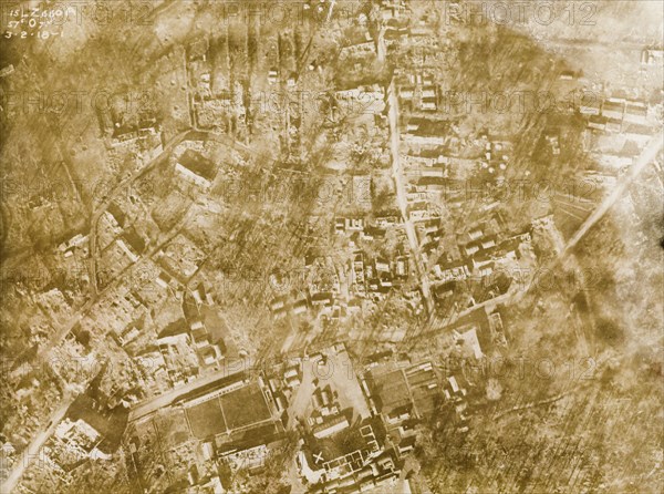 Aerial view of a bomb-damaged village. One of a series of British aerial reconnaissance photographs recording the positions of trenches on the Western Front during the First World War. A small French village lies in ruins, riddled with bomb craters, after suffering a continuous barrage of artillery fire. Nord-Pas de Calais or Picardie, France, 3 February 1918. France, Western Europe, Europe .