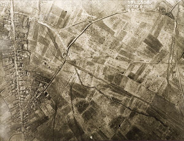 Aerial view of a bomb-damaged village. One of a series of British aerial reconnaissance photographs recording the positions of trenches on the Western Front during the First World War. Trenches zig-zag their way across fields pockmarked with bomb craters on the outskirts of a small village. Nord-Pas de Calais or Picardie, France, 2 February 1918., Nord-Pas de Calais, France, Western Europe, Europe .