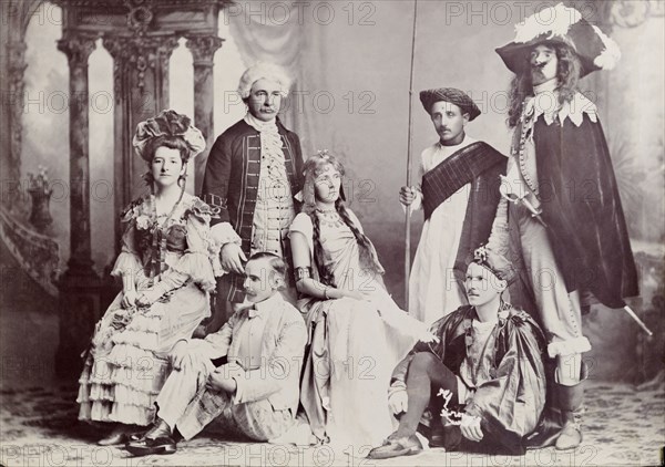 British amateur dramatics in India. Group portrait of British actors wearing fancy dress costume whilst participating in amateur dramatics at Poona. Amongst the group are Sir Henry Staveley Lawrence (Collector of Karachi) (standing, left) and his first wife Phyllis (centre). Poona, Bombay Presidency (Pune, Maharashtra), India, circa 1910. Pune, Maharashtra, India, Southern Asia, Asia.