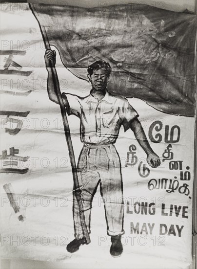 Long Live May Day'. A hand-painted banner from the Singaporean Merdeka (independence) movement celebrates May Day. The text reads 'Long Live May Day' and is written in Malay, Chinese, Tamil and English script. Singapore, circa 1956. Singapore, South East Asia, Asia.