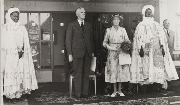 Official opening of Queen Elizabeth Girls' School. Princess Mary, Countess of Harewood, is accompanied by Kenneth Maddocks (Deputy Governor of Northern Nigeria) and Ahmadu Bello (Sardauna of Sokoto) at the official opening ceremony of Queen Elizabeth Girls' School. Ilorin, Nigeria, 21 November 1957. Ilorin, Kwara, Nigeria, Western Africa, Africa.